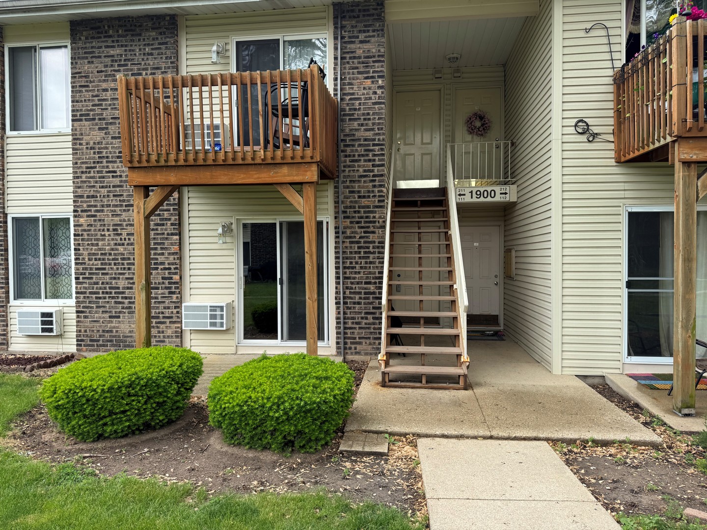 1900 Light Road, Unit 111 Oswego, IL 60543 - Photo 1 of 9 a front view of a house with garden