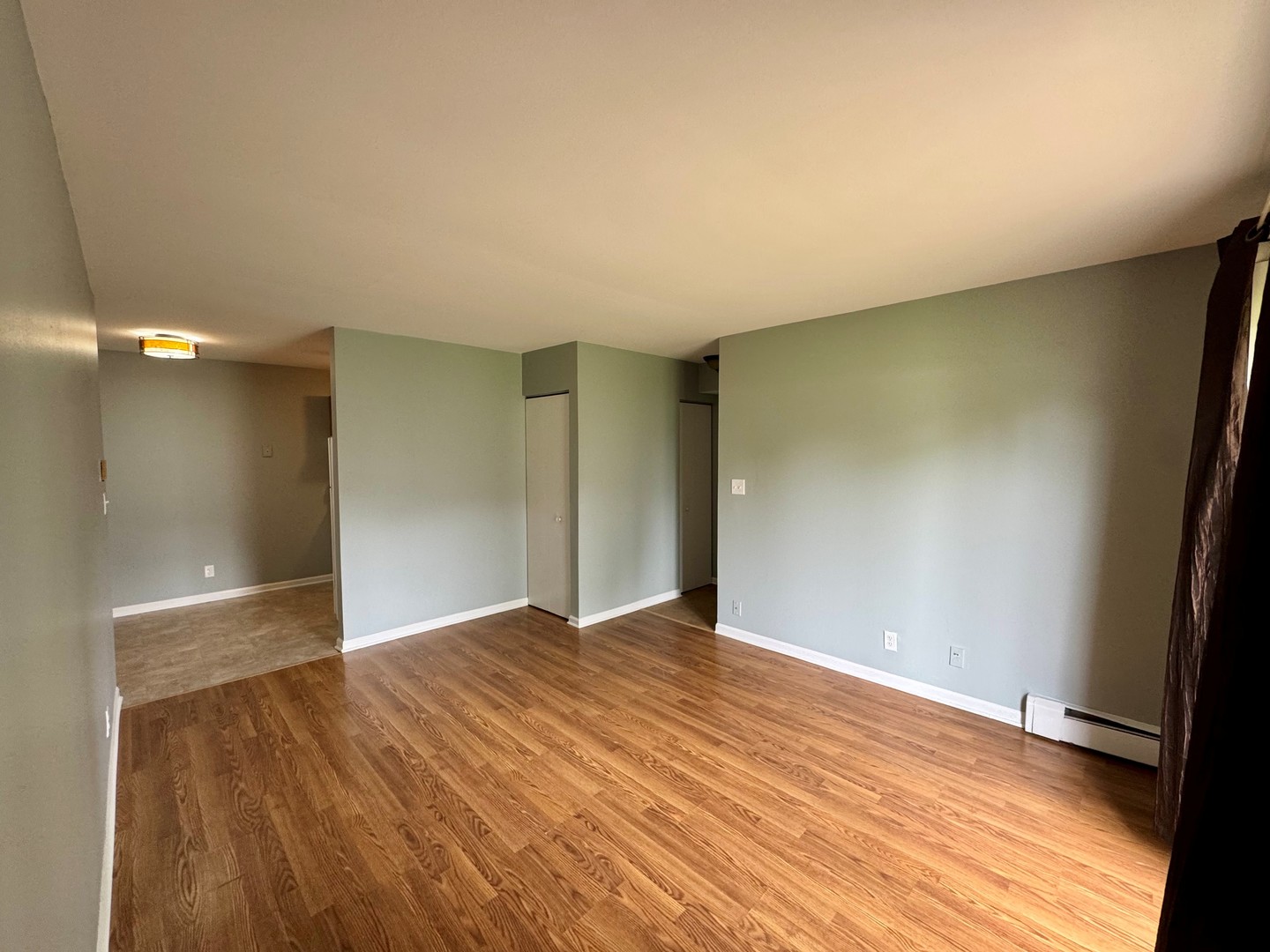 1900 Light Road, Unit 111 Oswego, IL 60543 - Photo 2 of 9 a view of an empty room with wooden floor