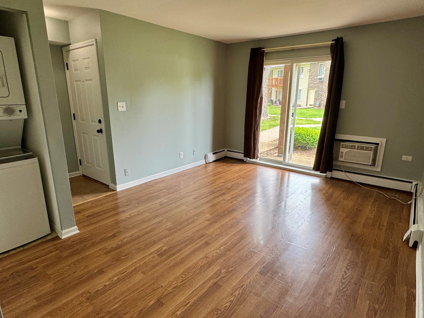1900 Light Road, Unit 111 Oswego, IL 60543 - Photo 4 of 9 an empty room with wooden floor and entrance