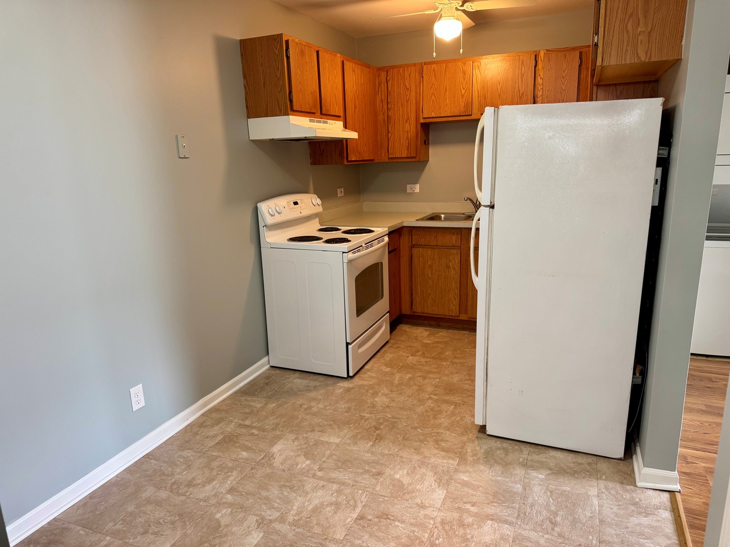 1900 Light Road, Unit 111 Oswego, IL 60543 - Photo 6 of 9 a kitchen with stainless steel appliances a refrigerator and a stove