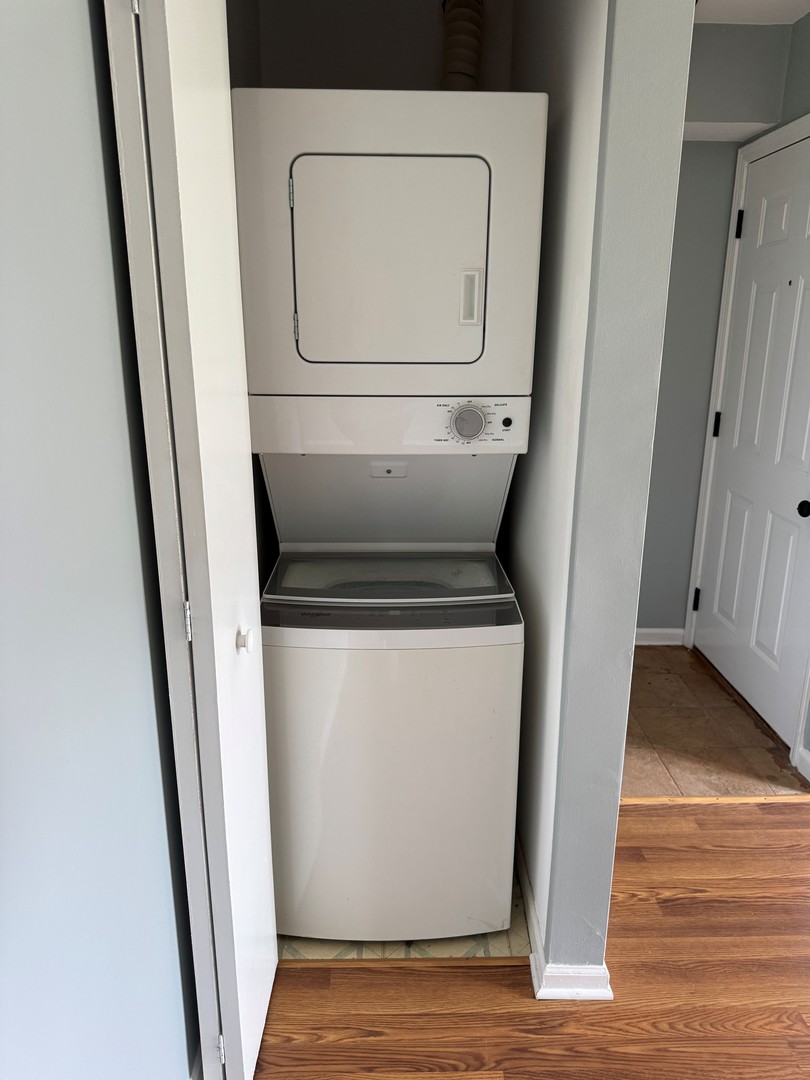 1900 Light Road, Unit 111 Oswego, IL 60543 - Photo 9 of 9 a utility room with wooden floor washer and dryer