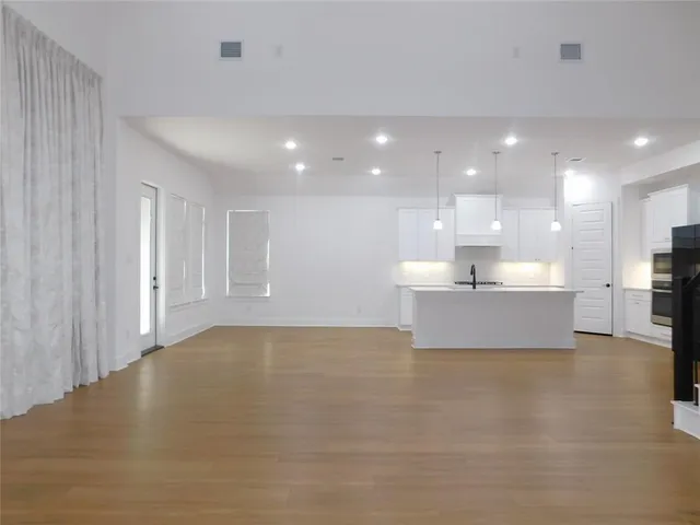 a kitchen with a sink stainless steel appliances and cabinets