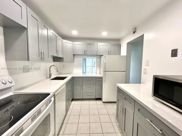 a kitchen with a sink a stove and refrigerator