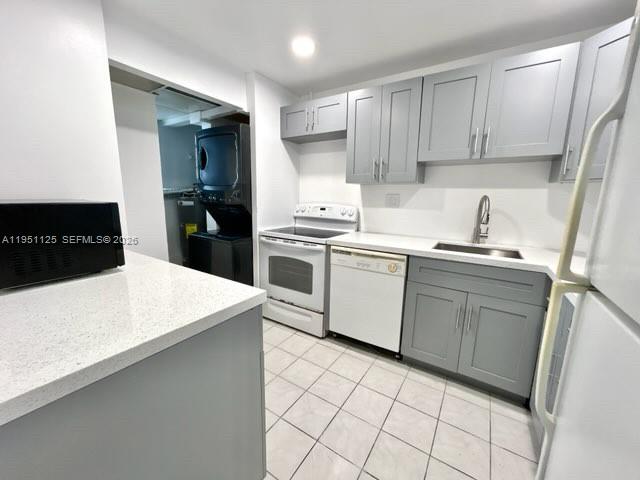 8020 North Colony Circle, Unit 203 Tamarac, FL 33321 - Photo 3 of 13 a kitchen with a sink a stove and refrigerator