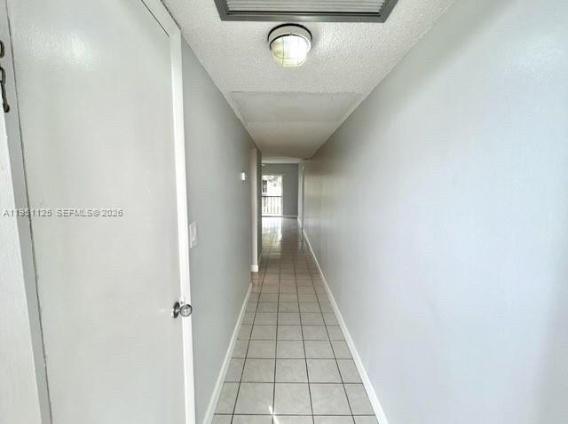 8020 North Colony Circle, Unit 203 Tamarac, FL 33321 - Photo 10 of 13 a view of hallway with wooden floor