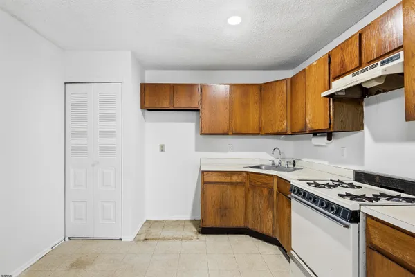a kitchen with a sink stove and cabinets