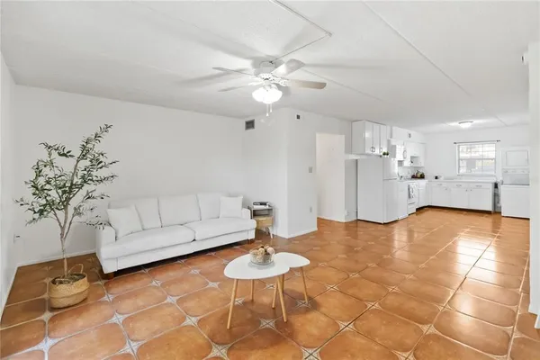 a living room with furniture and a chandelier