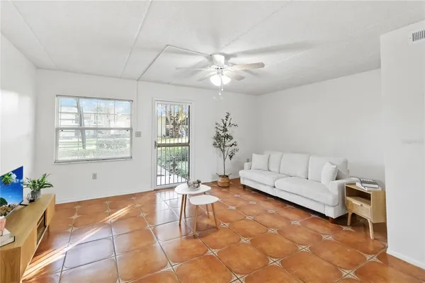 a living room with furniture and a large window