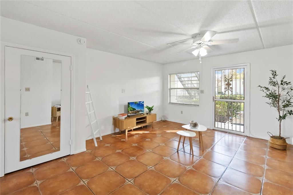 525 South Conway Road, Unit 29 Orlando, FL 32807 - Photo 6 of 29 a living room with fireplace furniture and a window