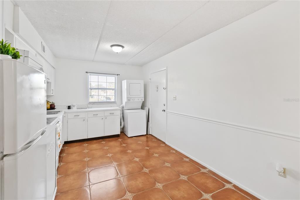 525 South Conway Road, Unit 29 Orlando, FL 32807 - Photo 10 of 29 a view of a kitchen with white cabinets and wooden floor