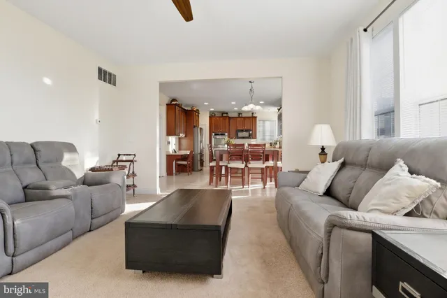 a kitchen with stainless steel appliances granite countertop a sink counter space cabinets and a large window