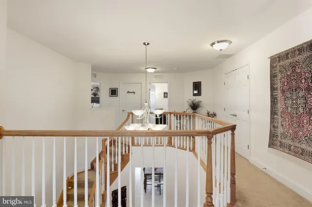 a spacious bedroom with a bed and a chandelier