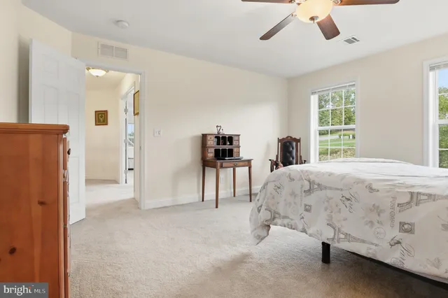 a view of a dining room with furniture and a potted plant