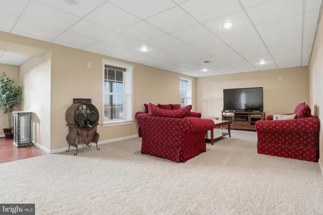 an aerial view of a house with a garden and lake view