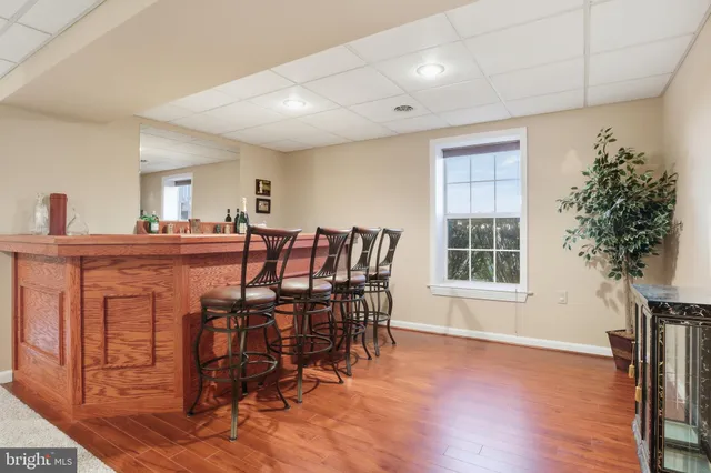 a aerial view of a house with a big yard and large trees