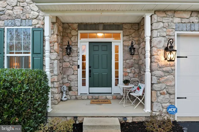 a dining room with furniture a chandelier and wooden floor