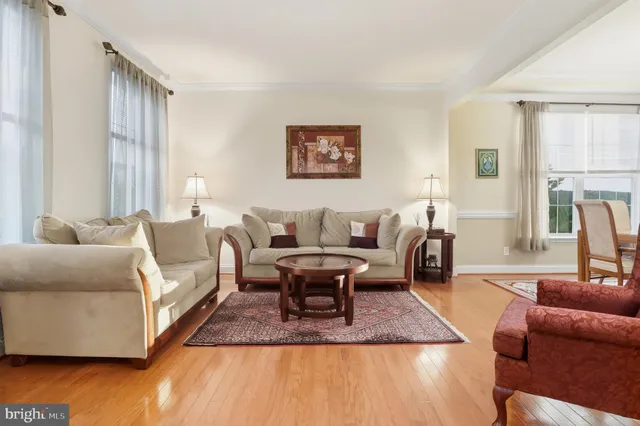 a kitchen with stainless steel appliances a table and chairs in it