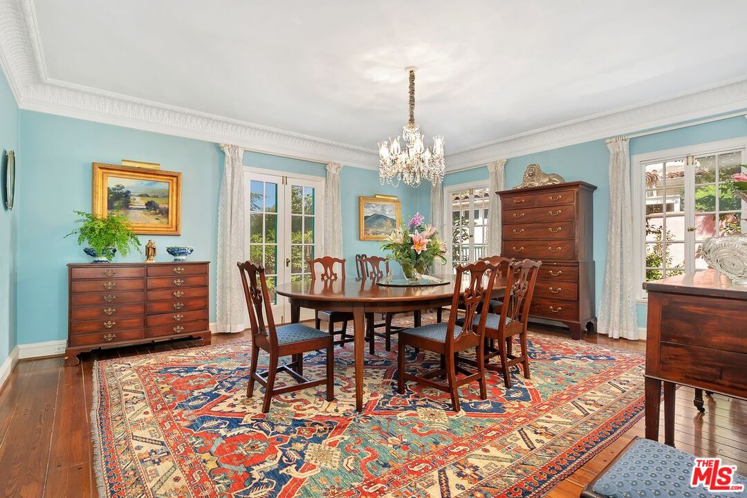208 South Plymouth Boulevard Los Angeles, CA 90004 - Photo 18 of 44 a view of a dining room with furniture a rug and wooden floor
