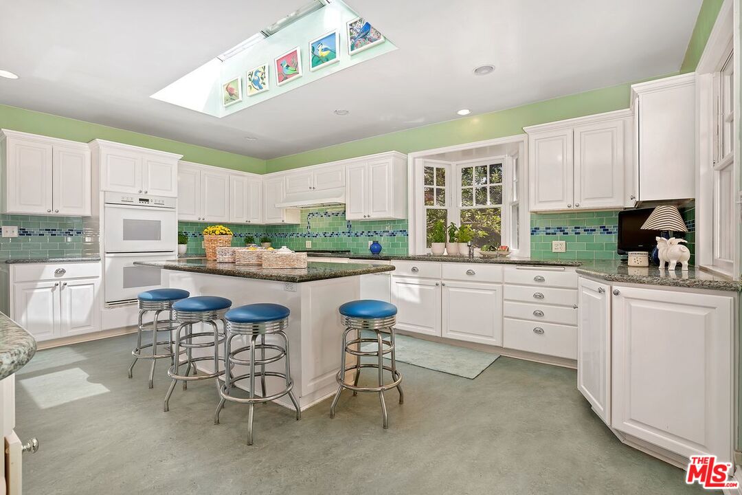 208 South Plymouth Boulevard Los Angeles, CA 90004 - Photo 22 of 44 a kitchen with appliances a sink and cabinets