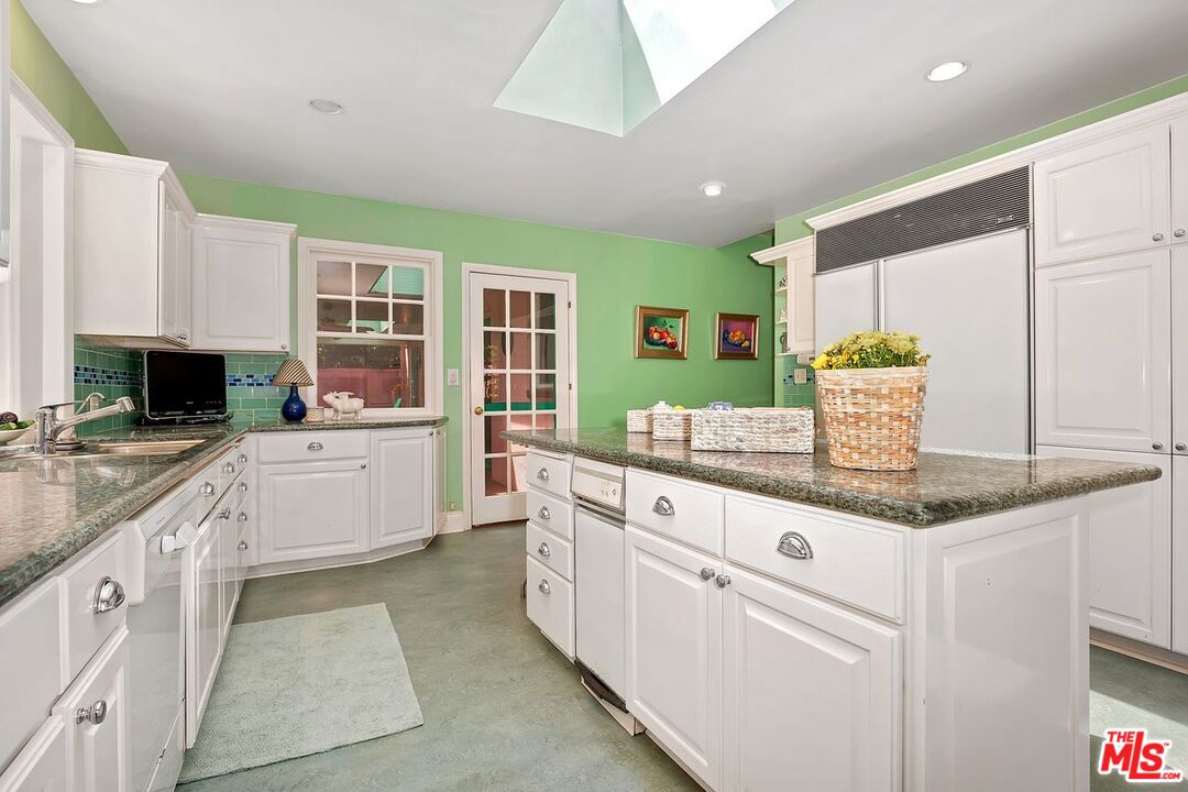 208 South Plymouth Boulevard Los Angeles, CA 90004 - Photo 23 of 44 a kitchen with stainless steel appliances granite countertop a sink and a stove