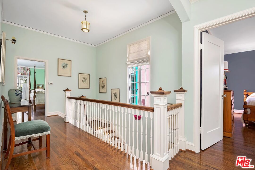 208 South Plymouth Boulevard Los Angeles, CA 90004 - Photo 30 of 44 a view of a hallway to a livingroom with wooden floor and furniture