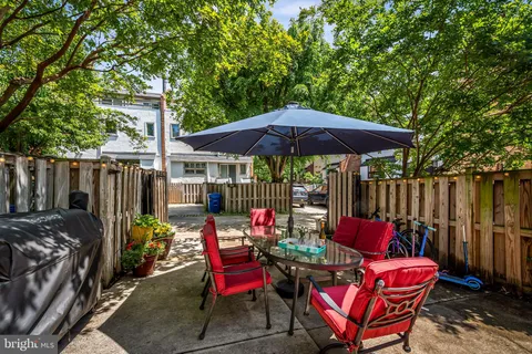 a view of a chairs and table in backyard