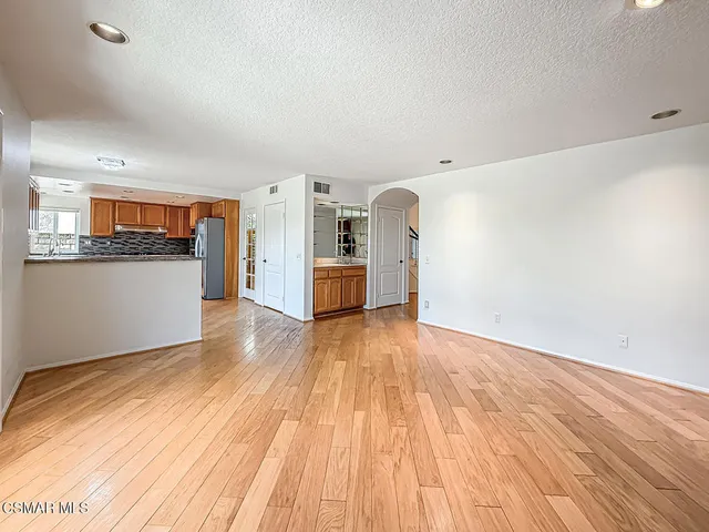 a kitchen with granite countertop a refrigerator and a sink