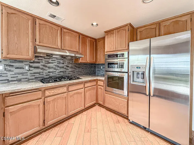 a kitchen with a sink and a refrigerator