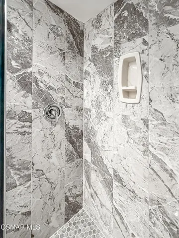 a view of a tennis ground with large trees