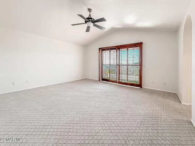 a view of a patio with table and chairs potted plants with floor to ceiling window