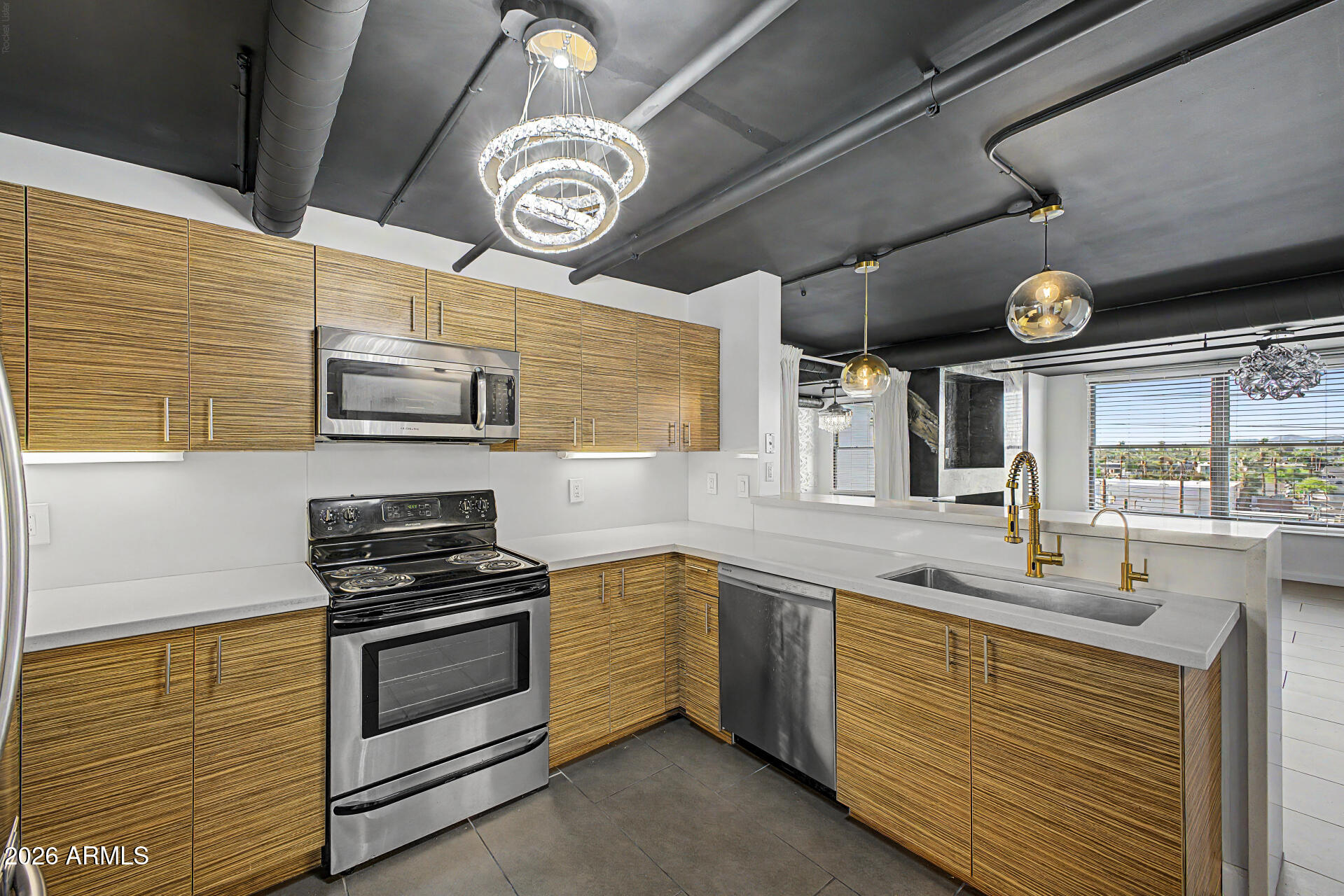 535 West Thomas Road, Unit 513 Phoenix, AZ 85013 - Photo 12 of 33 a kitchen with stainless steel appliances granite countertop a sink a stove and cabinets