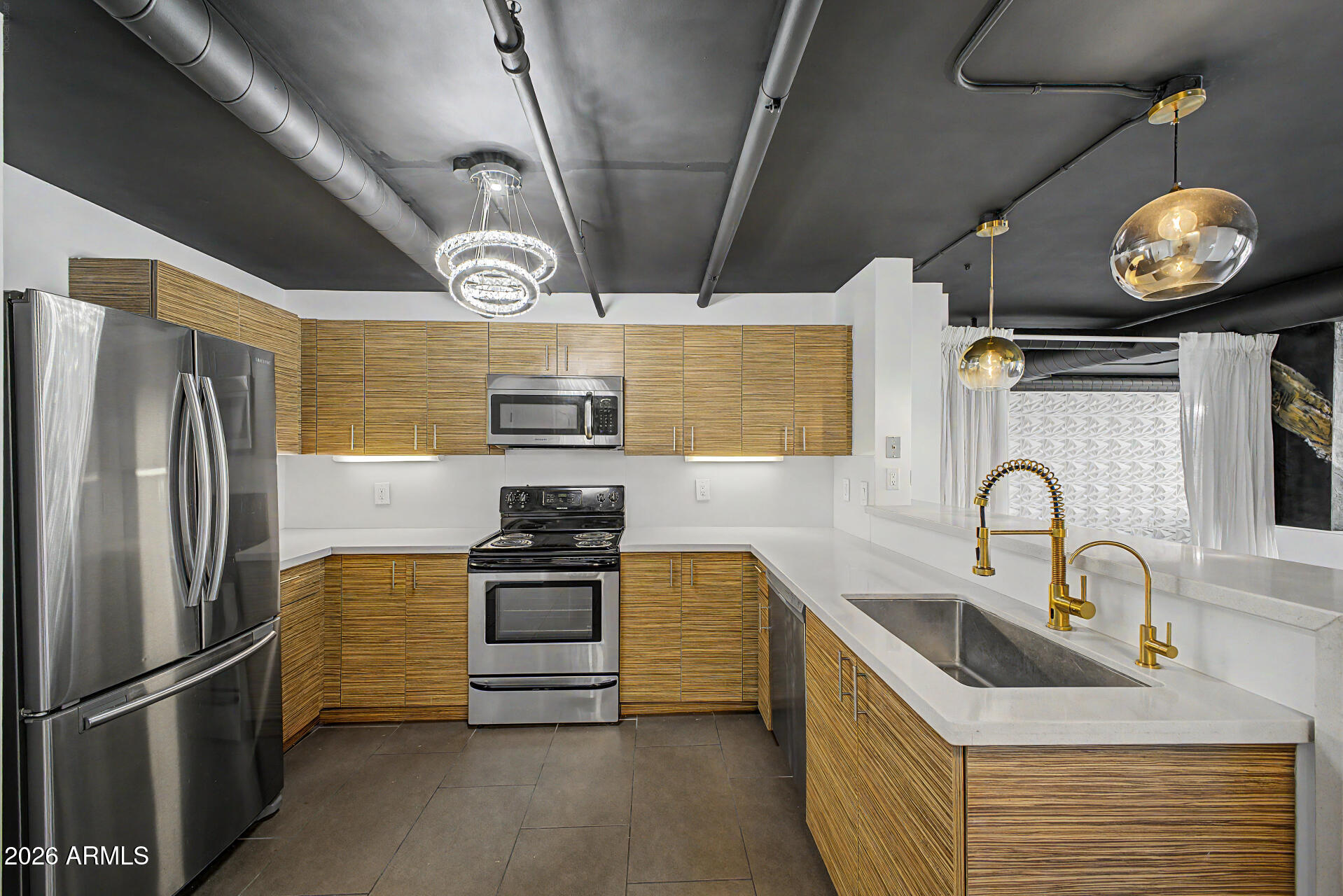 535 West Thomas Road, Unit 513 Phoenix, AZ 85013 - Photo 13 of 33 a kitchen with stainless steel appliances granite countertop a sink a stove and refrigerator