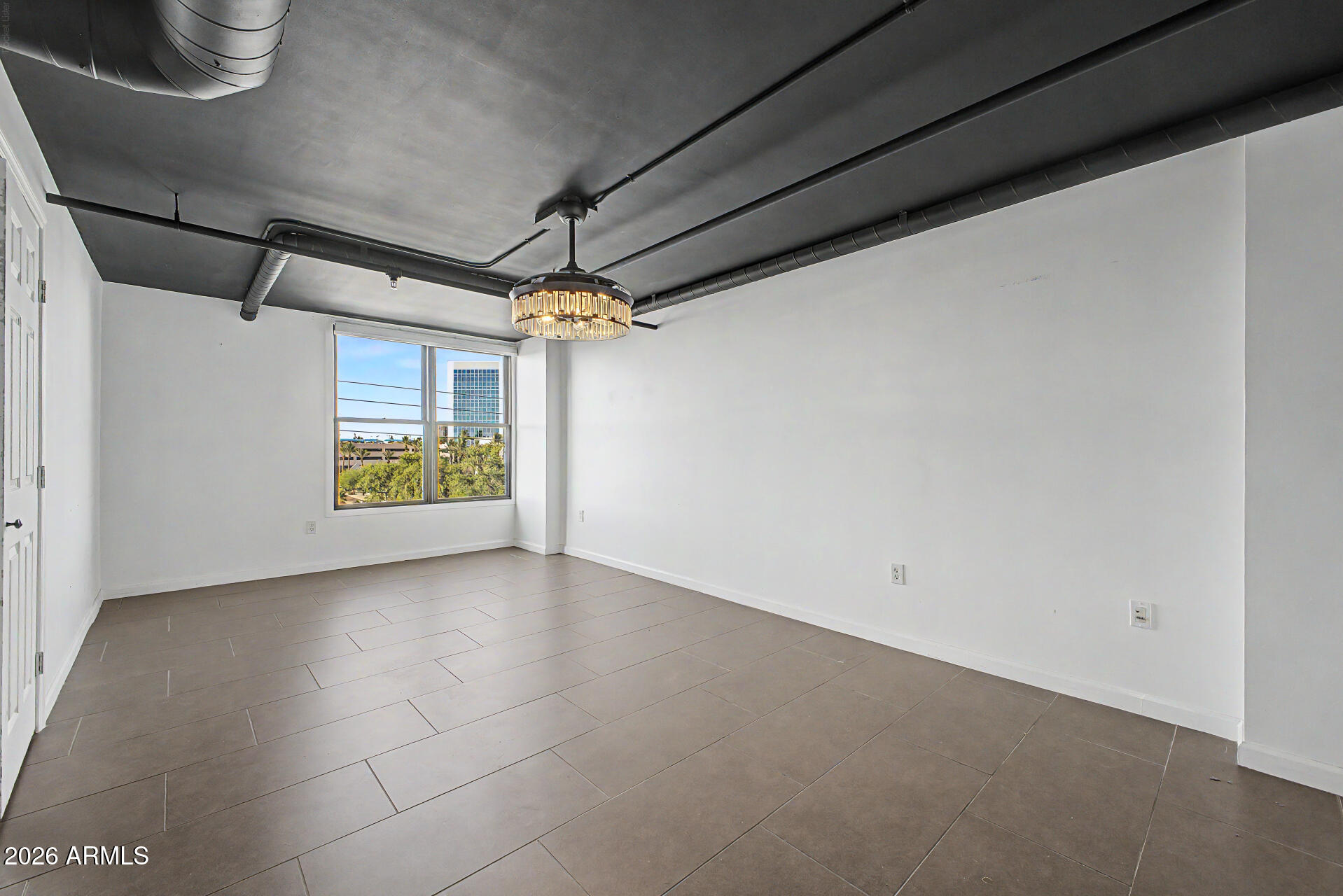 535 West Thomas Road, Unit 513 Phoenix, AZ 85013 - Photo 21 of 33 a view of an empty room with a window