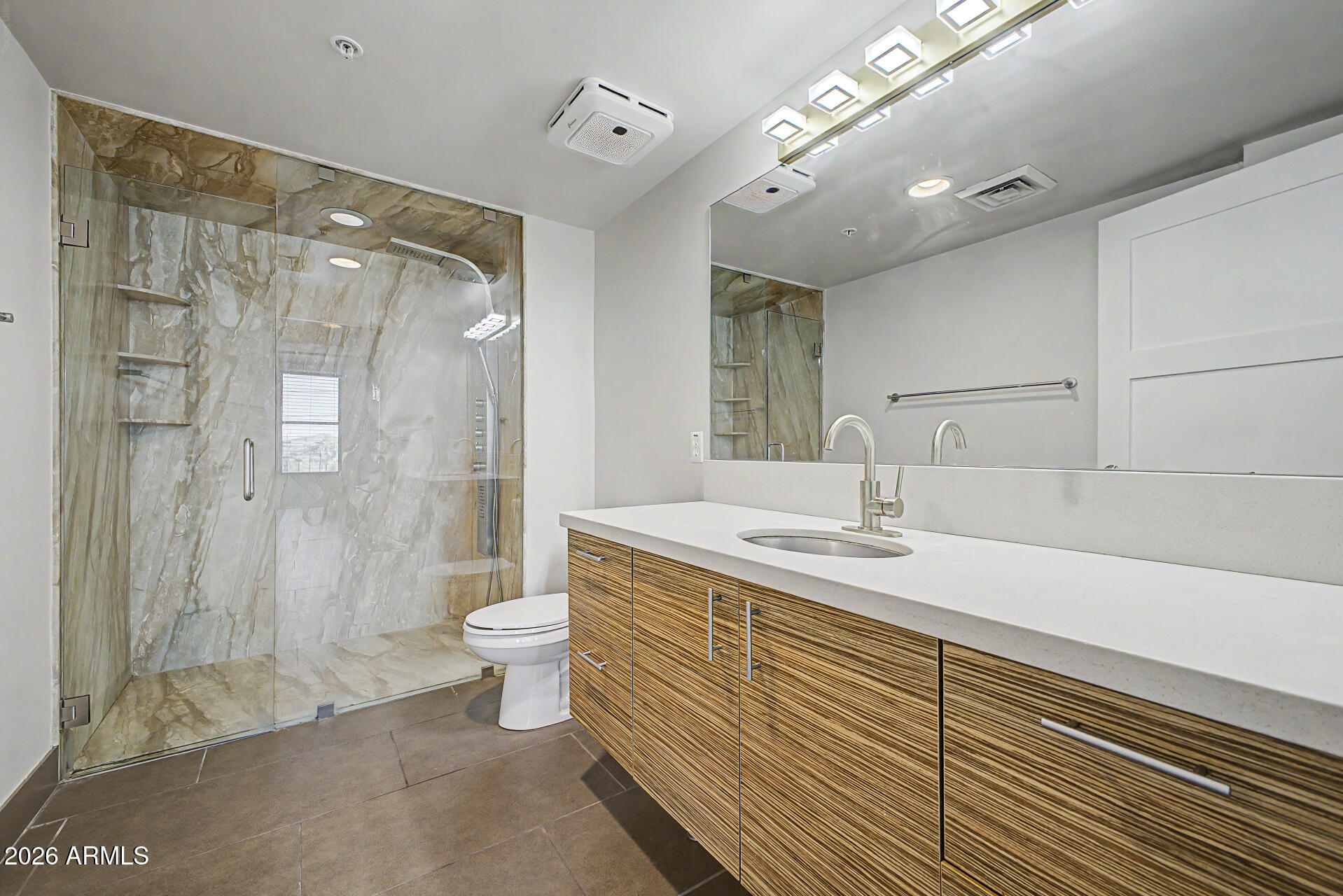535 West Thomas Road, Unit 513 Phoenix, AZ 85013 - Photo 23 of 33 a bathroom with a double vanity sink toilet and shower