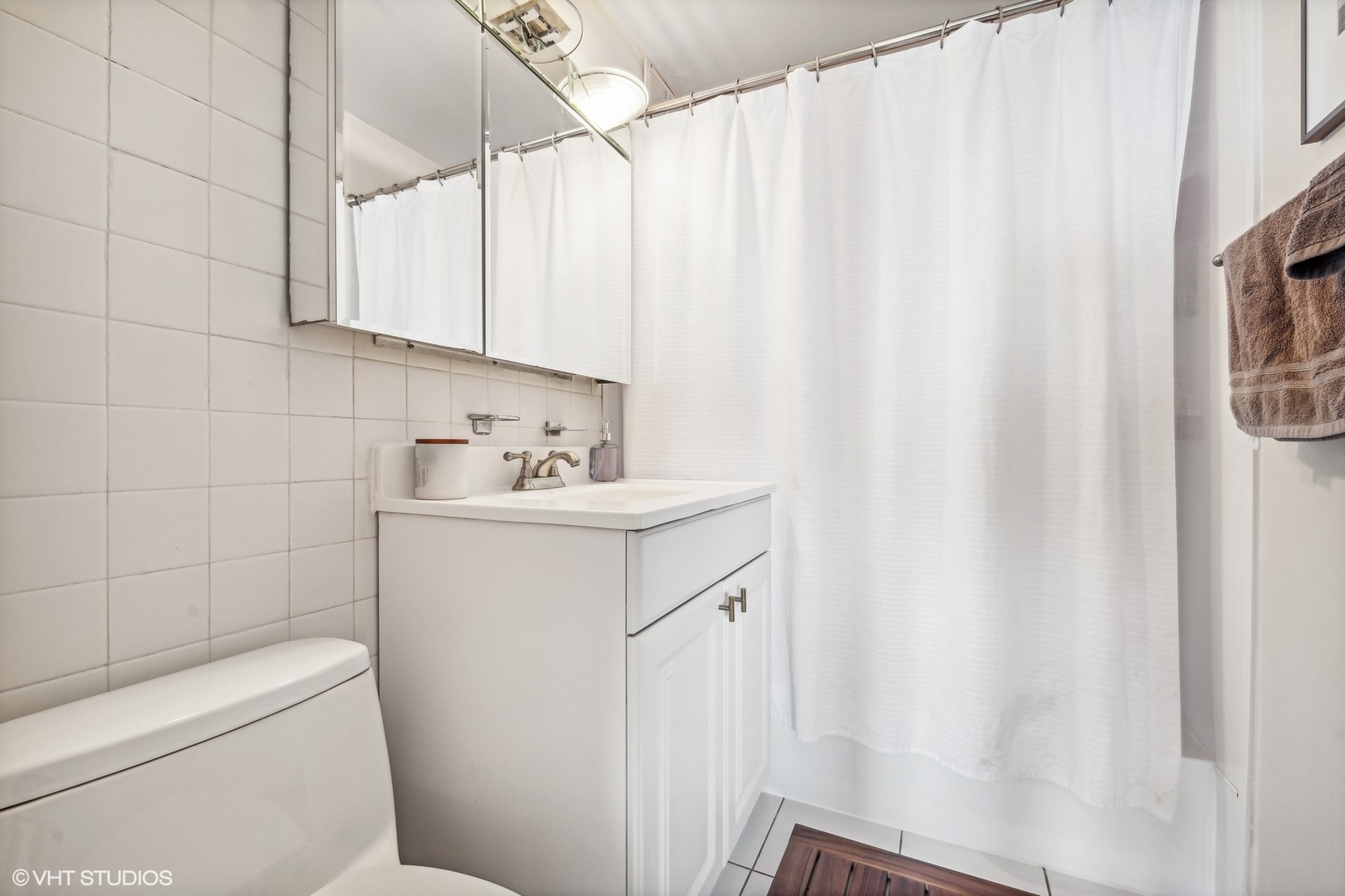 655 West Irving Park Road, Unit 1912 Chicago, IL 60613 - Photo 12 of 29 a bathroom with a sink a toilet and shower
