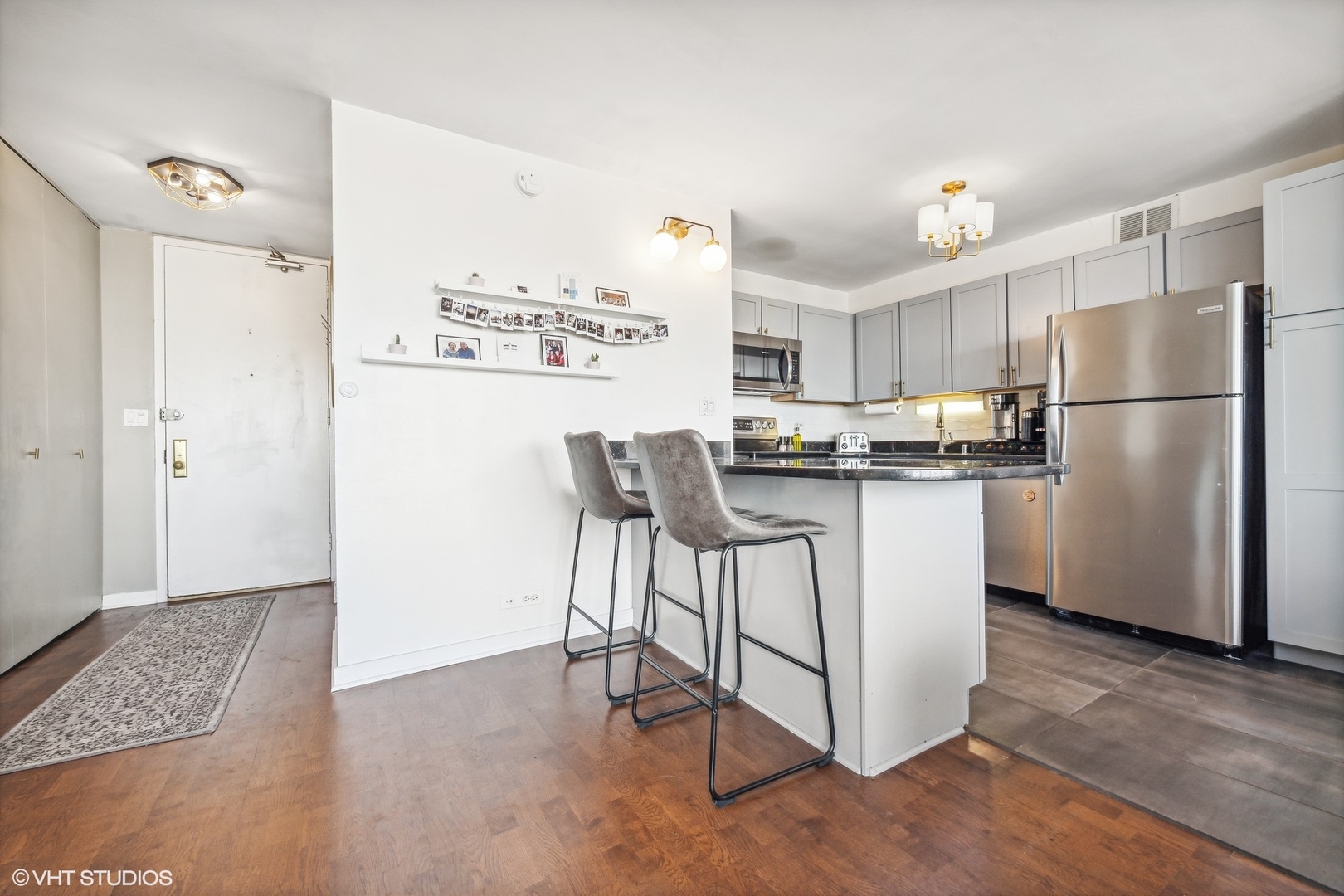 655 West Irving Park Road, Unit 1912 Chicago, IL 60613 - Photo 16 of 29 a kitchen with kitchen island a refrigerator and a stove top oven