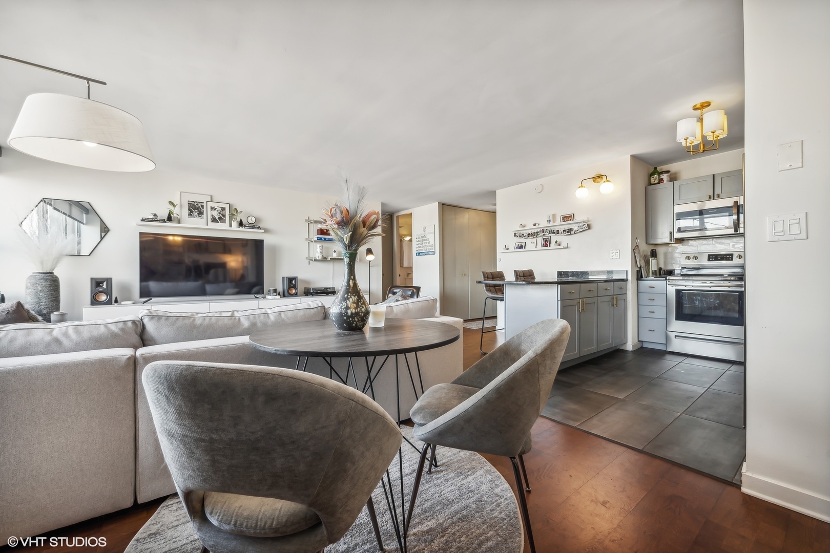 655 West Irving Park Road, Unit 1912 Chicago, IL 60613 - Photo 17 of 29 a living room with stainless steel appliances furniture a rug and a kitchen