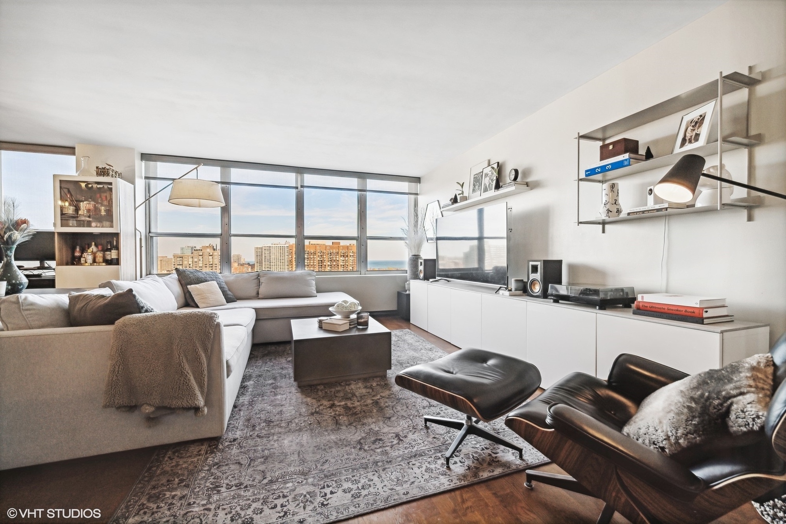 655 West Irving Park Road, Unit 1912 Chicago, IL 60613 - Photo 2 of 29 a living room with furniture and floor to ceiling windows