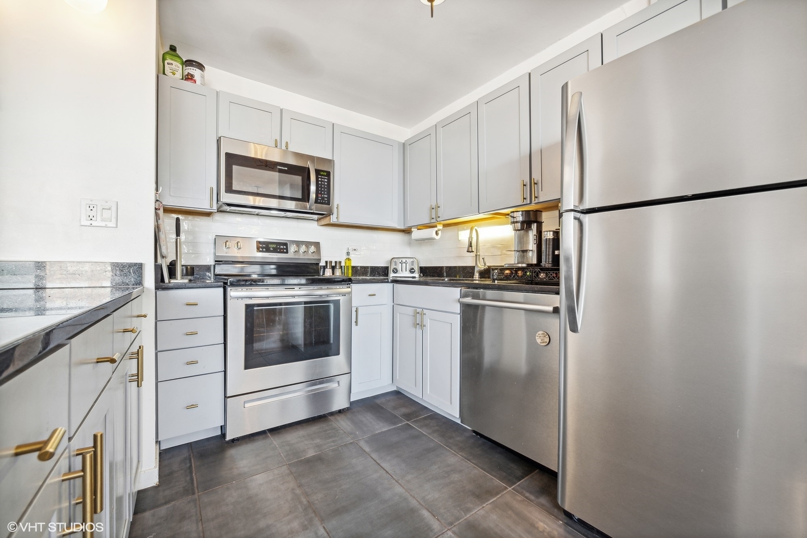 655 West Irving Park Road, Unit 1912 Chicago, IL 60613 - Photo 8 of 29 a kitchen with white cabinets and white appliances