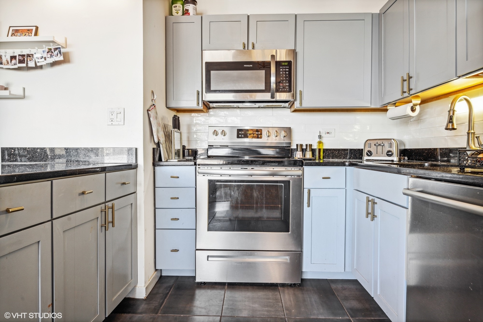 655 West Irving Park Road, Unit 1912 Chicago, IL 60613 - Photo 9 of 29 a kitchen with granite countertop white cabinets white stainless steel appliances and a sink