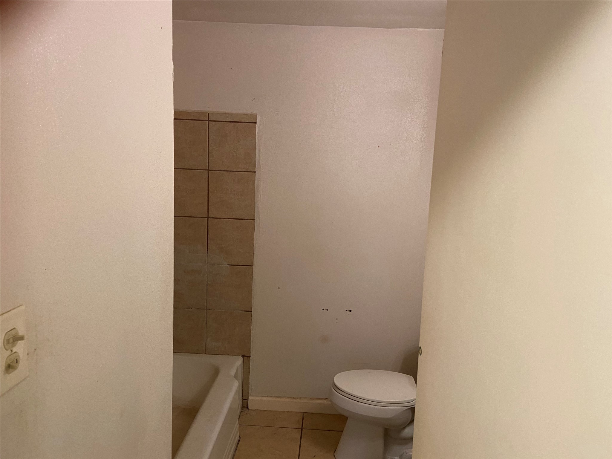 8730 Cowart Street Houston, TX 77029 - Photo 14 of 25 a white toilet sitting next to a shower