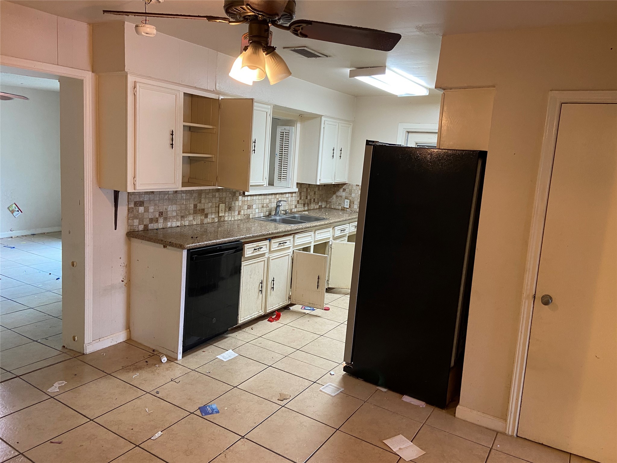 8730 Cowart Street Houston, TX 77029 - Photo 3 of 25 a kitchen with a refrigerator and a sink