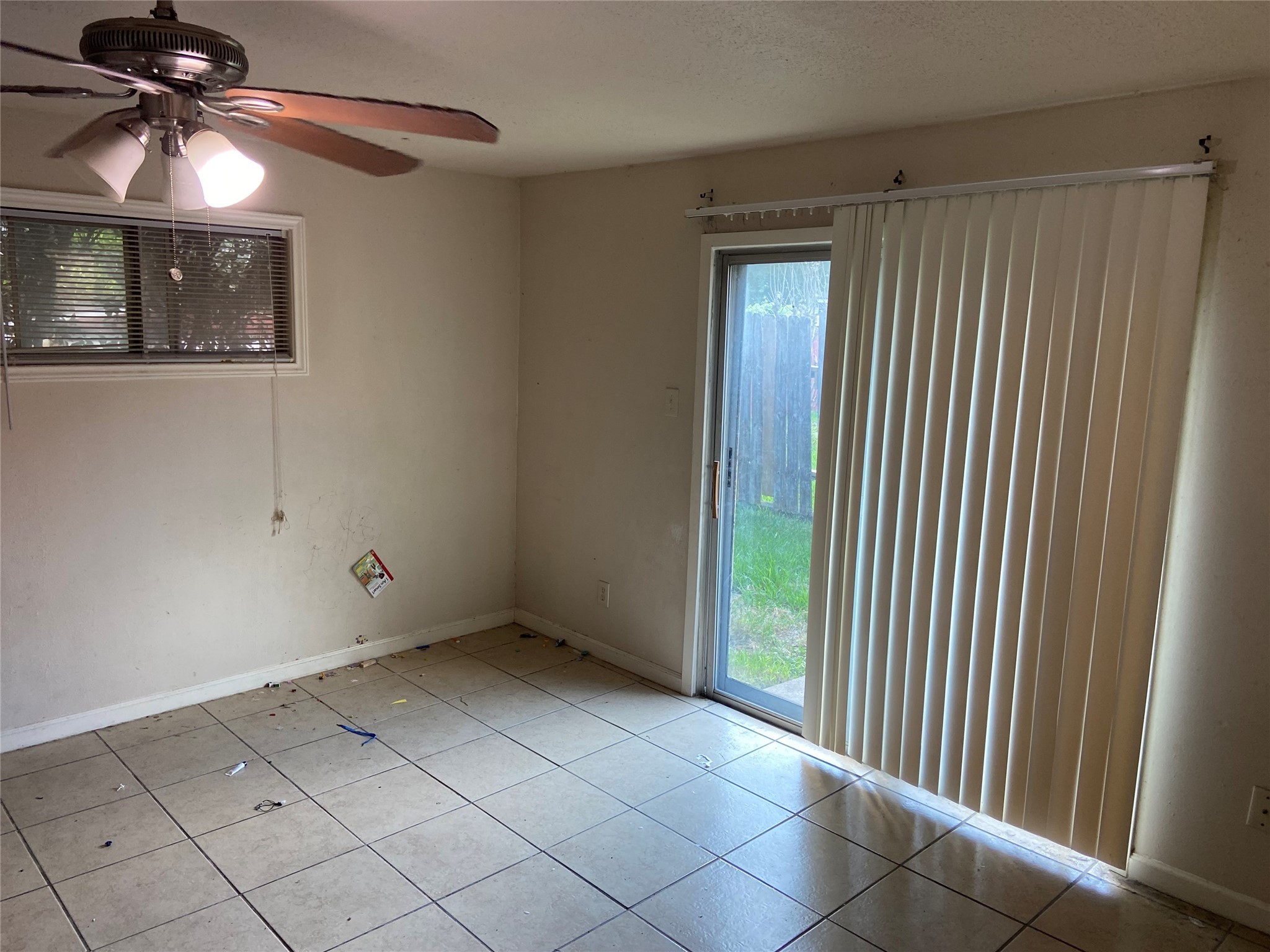 8730 Cowart Street Houston, TX 77029 - Photo 8 of 25 a view of an empty room with window and chandelier fan