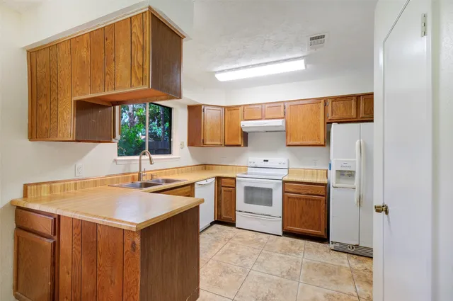 a kitchen with stainless steel appliances granite countertop a sink and cabinets