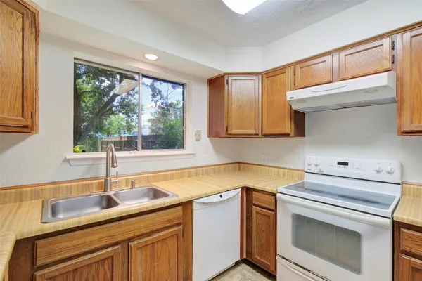 a kitchen with a sink and a window
