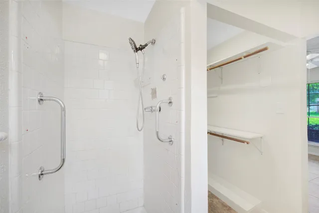 a bathroom with a glass shower door