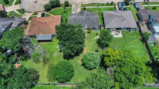 an aerial view of multiple houses with yard