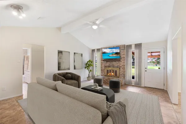 a living room with fireplace furniture and a wooden floor
