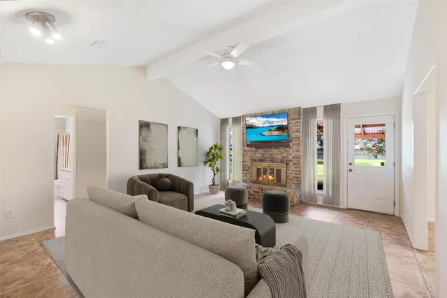 a living room with fireplace furniture and a wooden floor