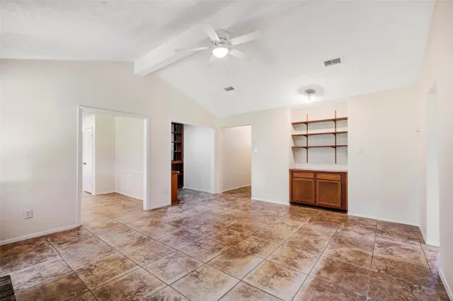 a view of an empty room with a ceiling fan